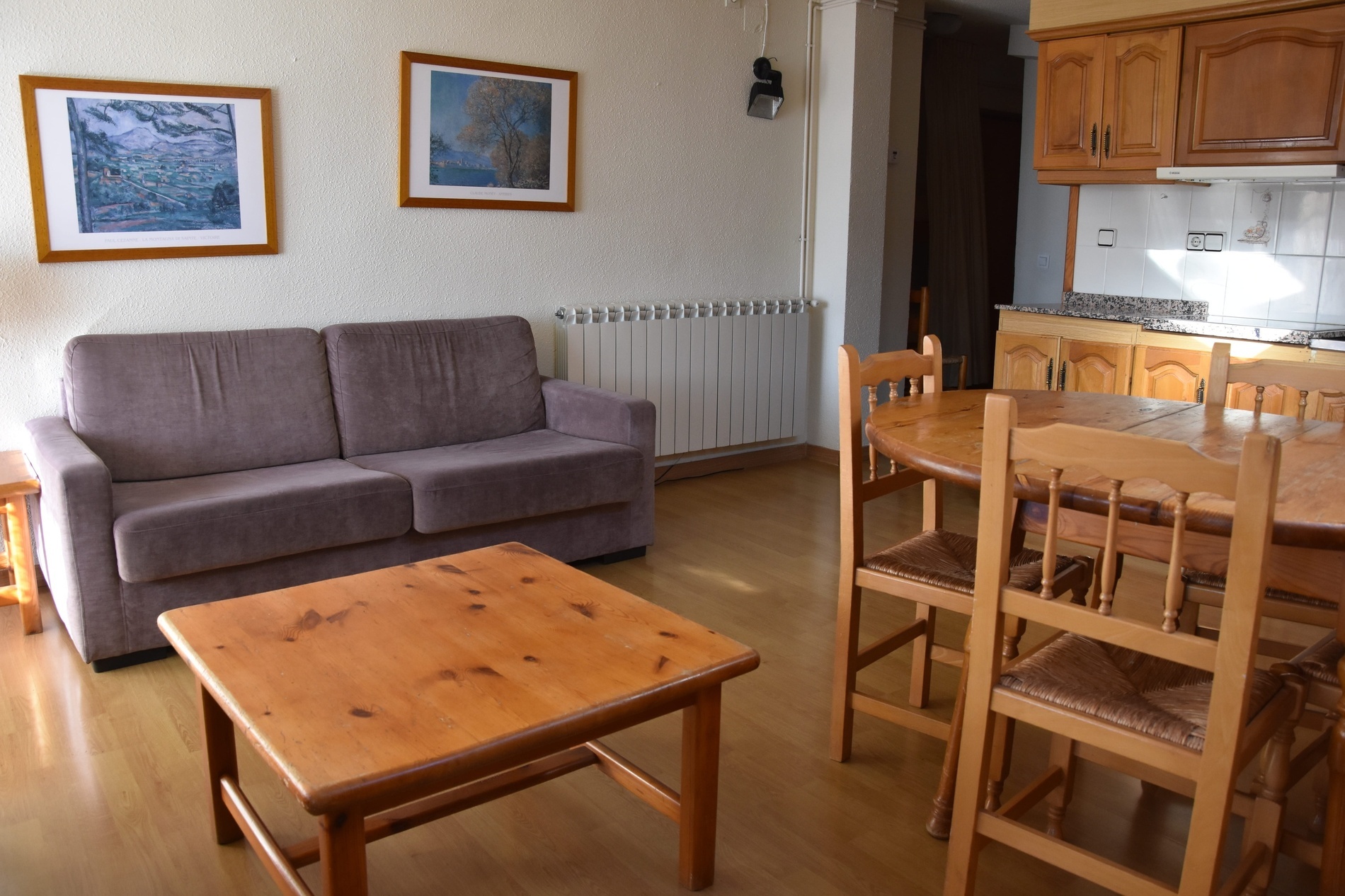 a living room with a table and chairs and a couch