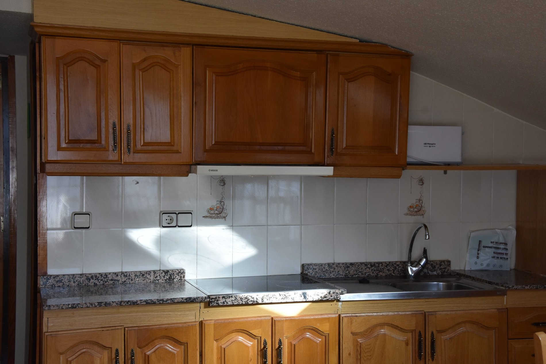 a kitchen with wooden cabinets and a box that says ' siemens ' on it