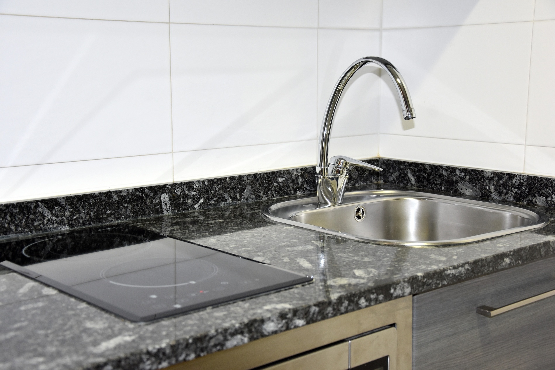 a kitchen with a sink and a stove top oven