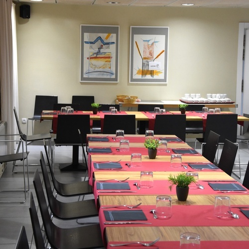 a room with tables and chairs and a sign that says ' a ' on it