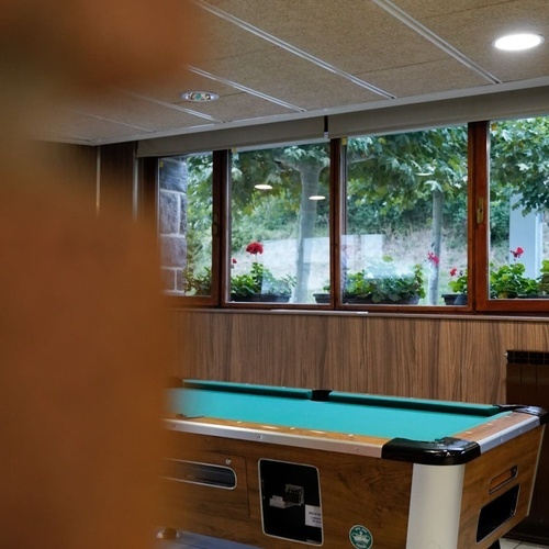 a pool table in a room with a window