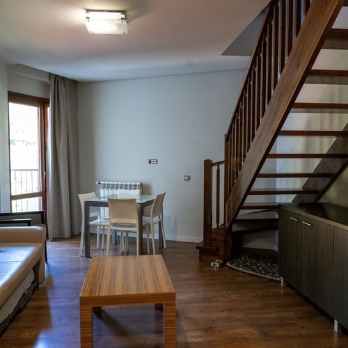 a living room with a staircase leading up to the second floor