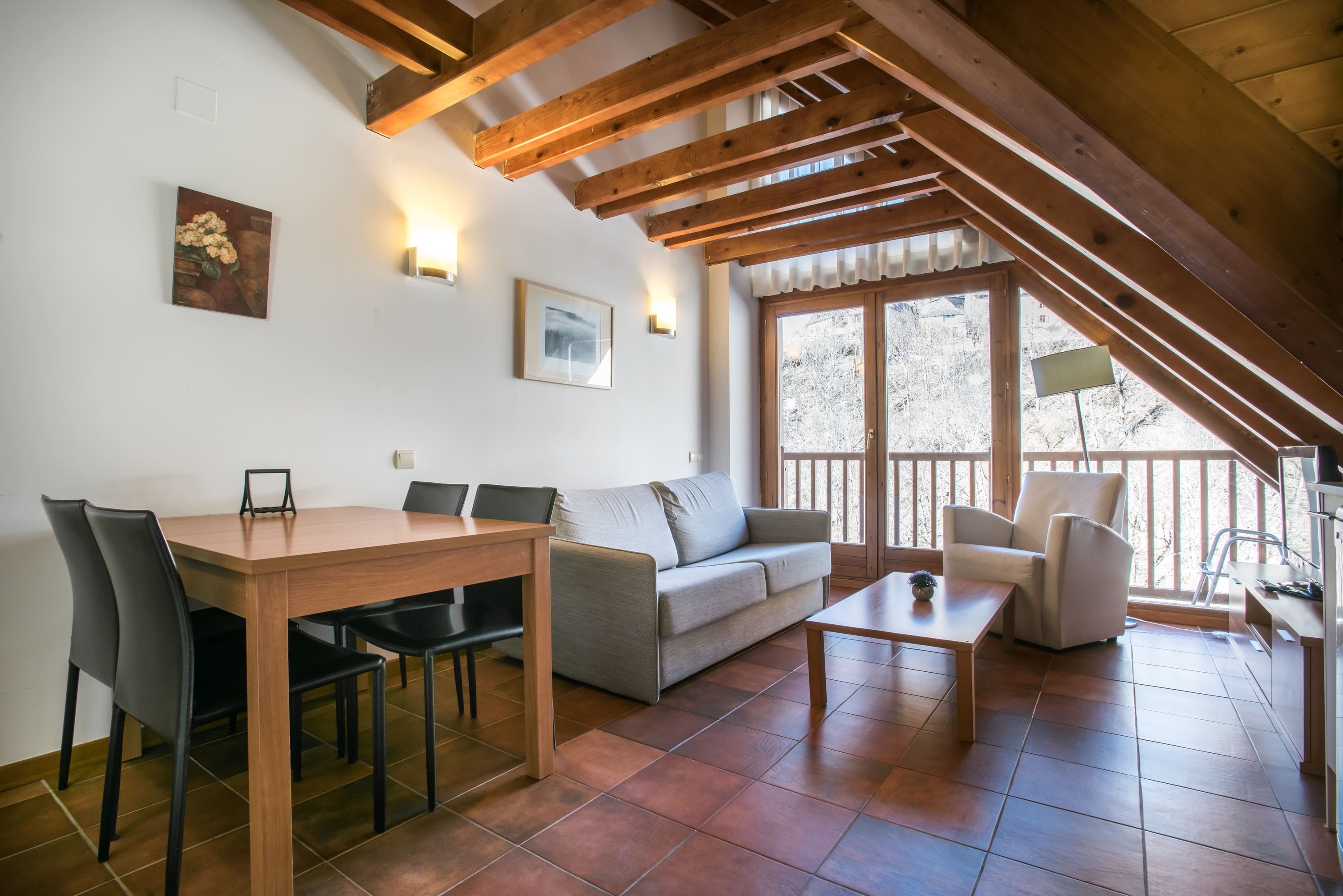 a living room with a couch a table and chairs