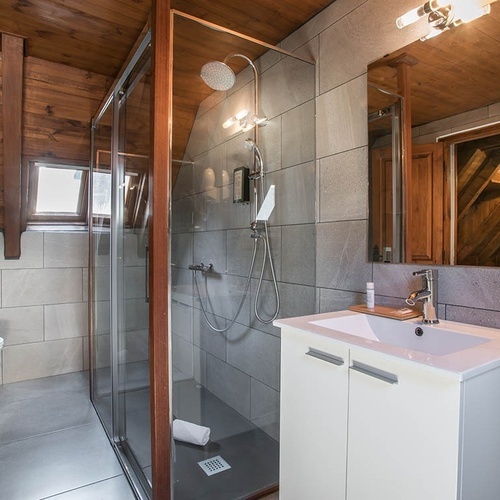 a bathroom with a white toilet and a white sink