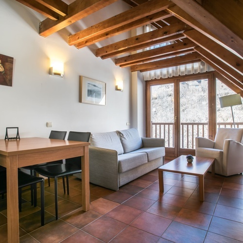 a living room with a couch a table and chairs