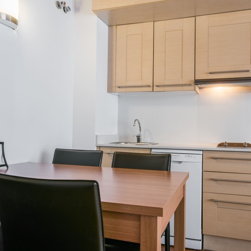 a kitchen with a table and chairs and a microwave