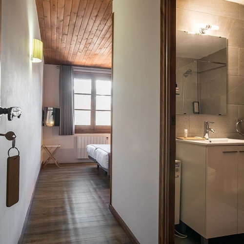 a hallway leading to a bathroom with a sink