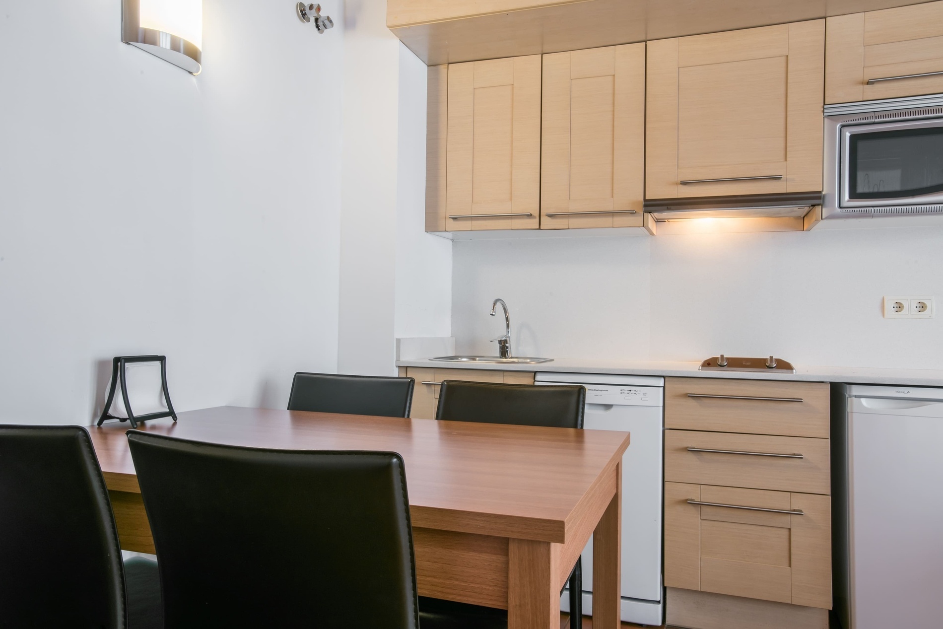 a kitchen with a table and chairs and a microwave