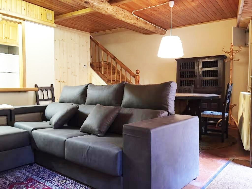 una sala de estar con un sofá y escaleras