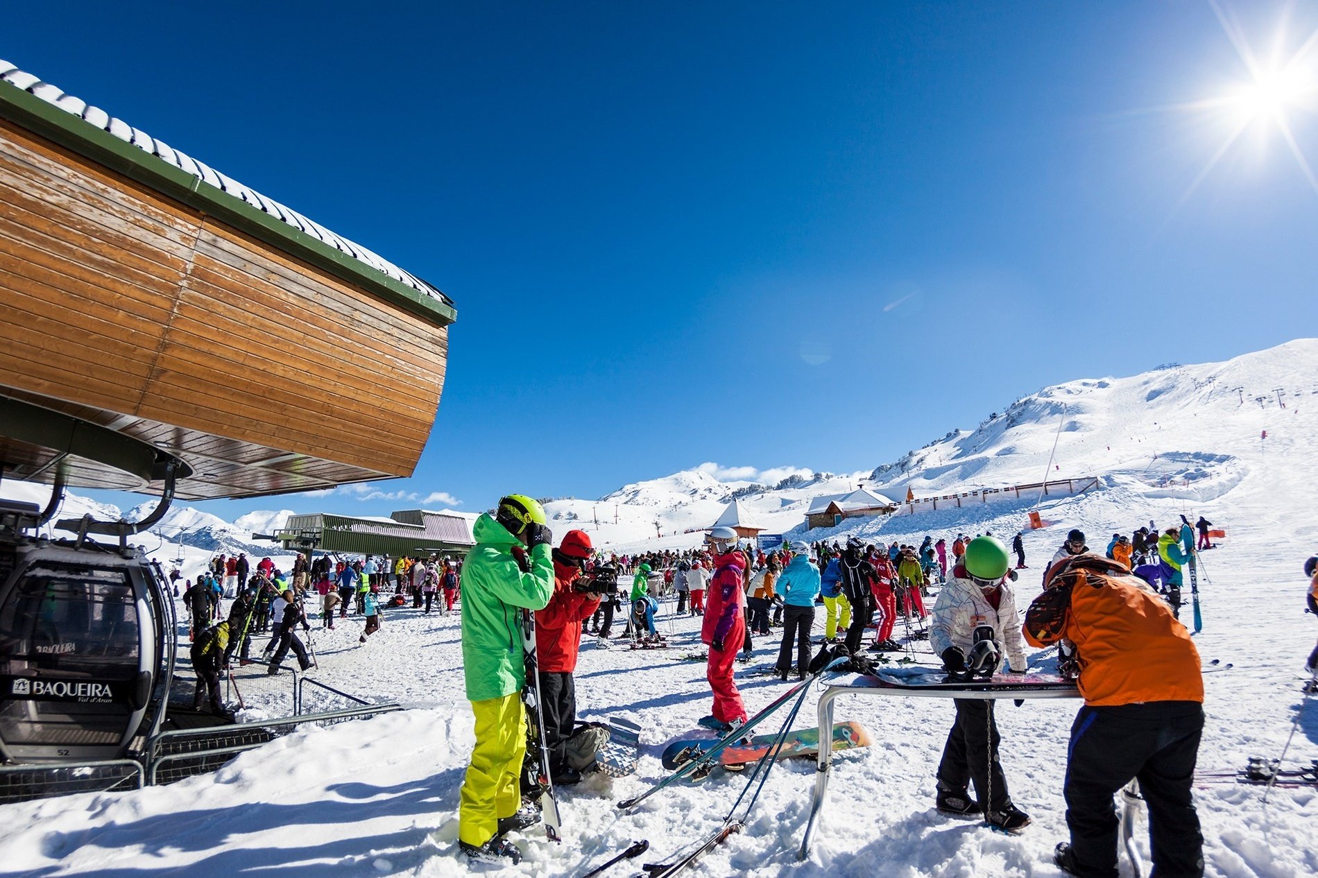 a group of skiers are gathered in the snow near a ski lift that says ' sierra ' on it