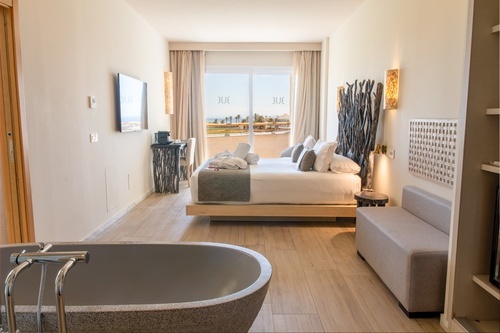 a hotel room with a large bed and a bathtub