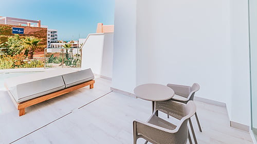 Balcony with lounge chair and table, offering Qhotels: Zahara Beach & SPA views.