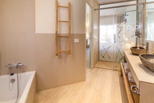 a bathroom with two sinks and a walk in shower