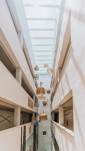 Qhotels: Zahara Beach & SPA atrium with wicker chandeliers and natural light, hotel lobby decor.
