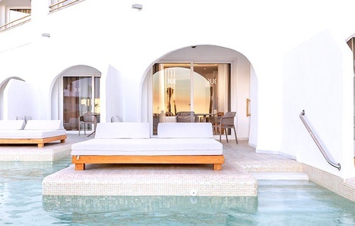 there is a large bed in the middle of the pool .