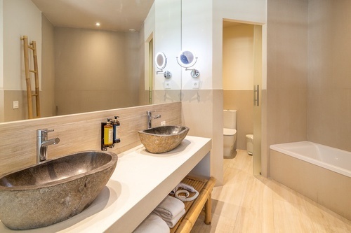 a bathroom with two sinks and a toilet