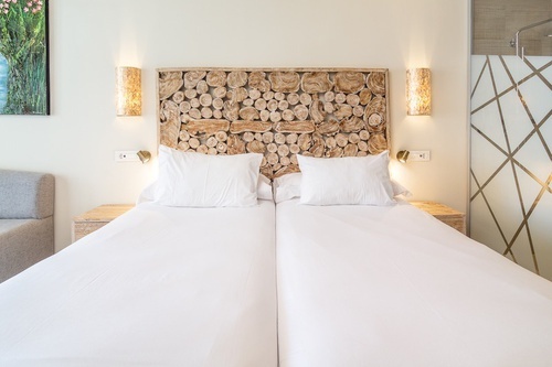 a bed with a headboard made out of logs