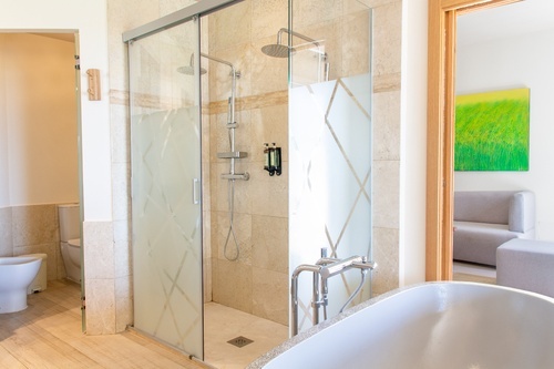 a bathroom with a walk in shower and a bathtub