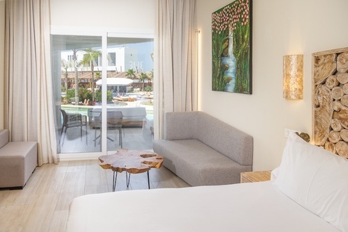 a hotel room with a couch and a table