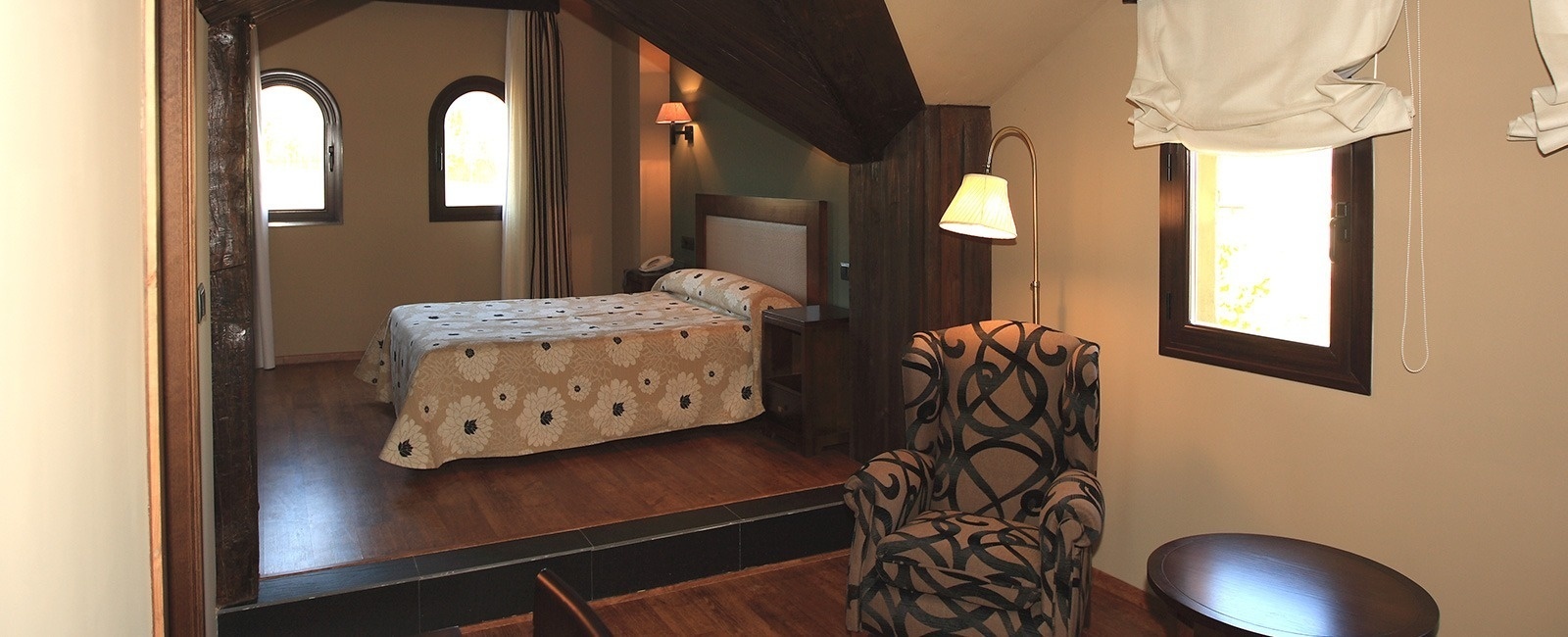 una habitación con una cama y una silla junto a una ventana