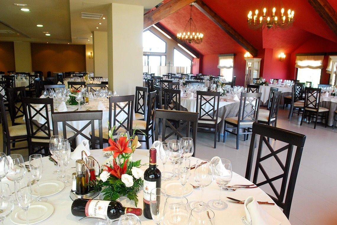 a bottle of wine sits on a table in a restaurant