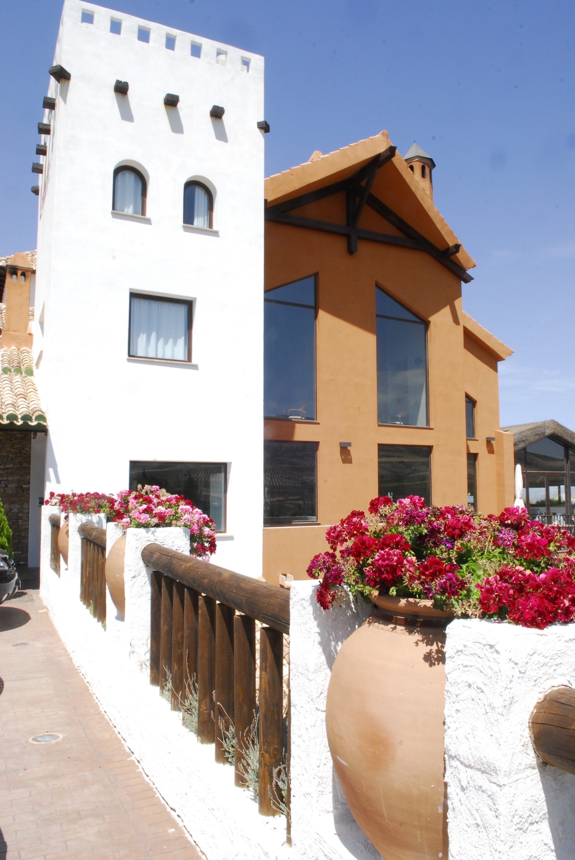 a building with a lot of windows and flowers in front of it