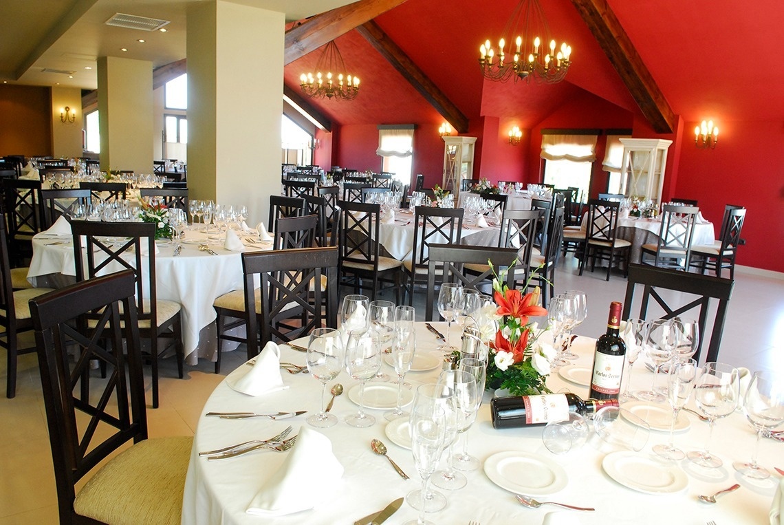 a bottle of wine sits on a table in a restaurant