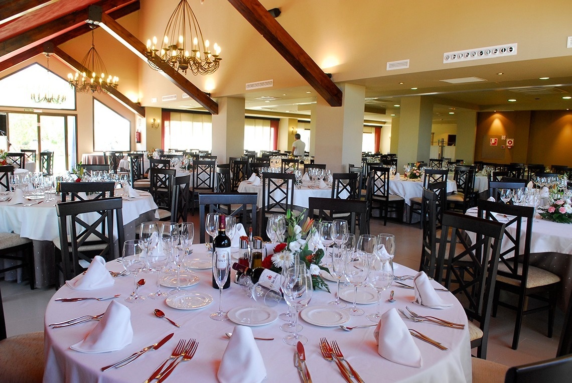 a restaurant with tables and chairs set up for a wedding reception