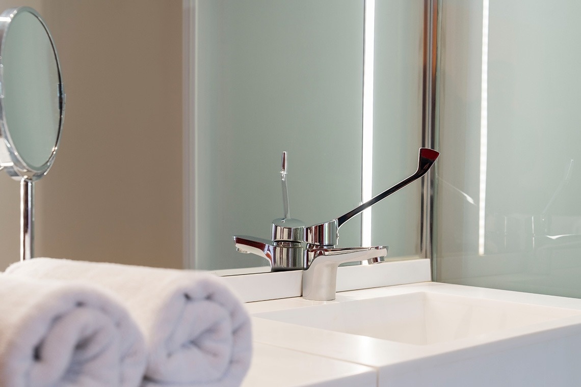 a bathroom sink with a faucet and a mirror