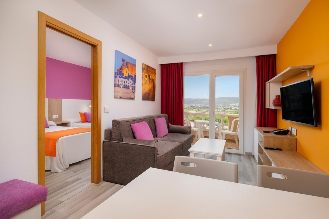 a hotel room with two beds and a balcony