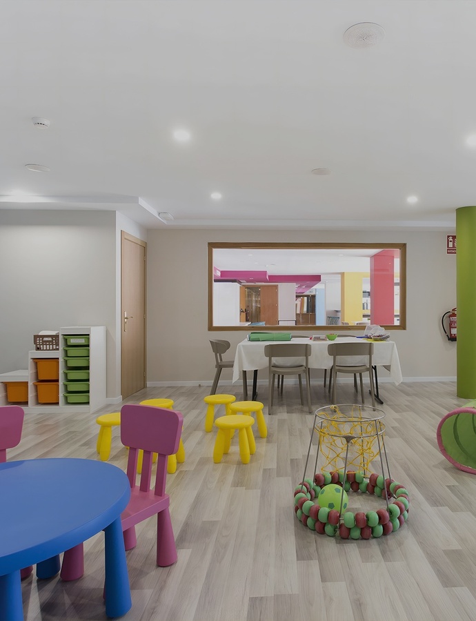 a person holding a martini in front of an infinity pool