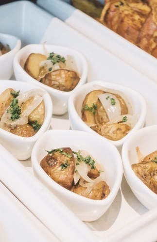 people sit at tables under a sign that says alfresco