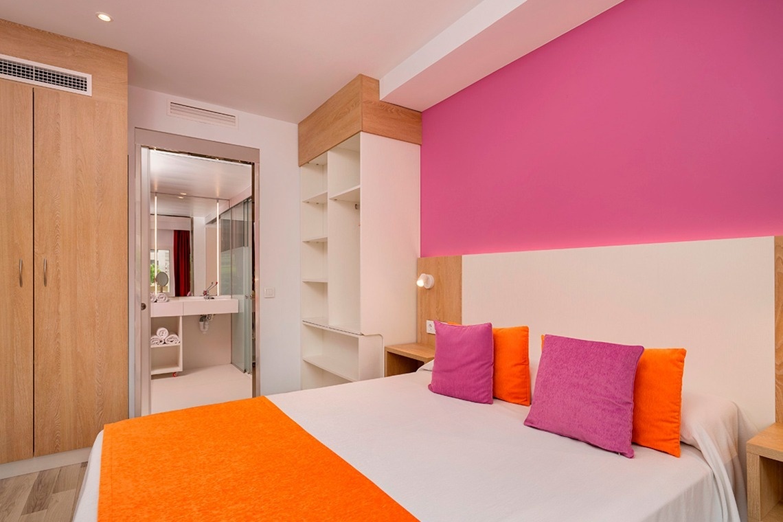 a hotel room with two beds and a balcony