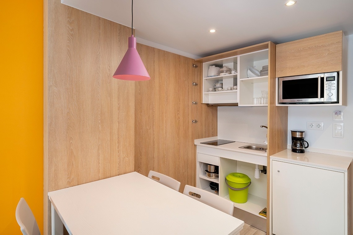 a small kitchen with a microwave and a table