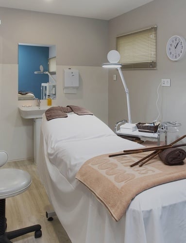 a restaurant with a chef preparing food in the background