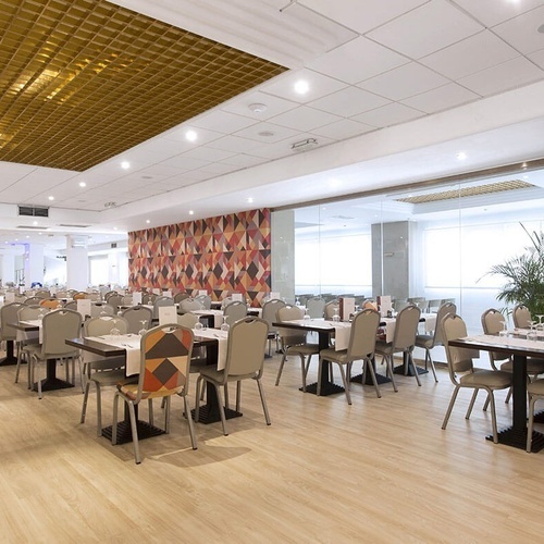 una larga fila de mesas y sillas en un restaurante