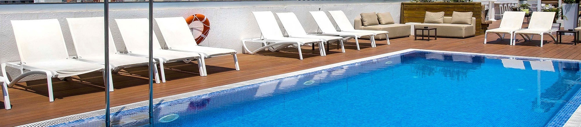 a patio with a couch and chairs under umbrellas