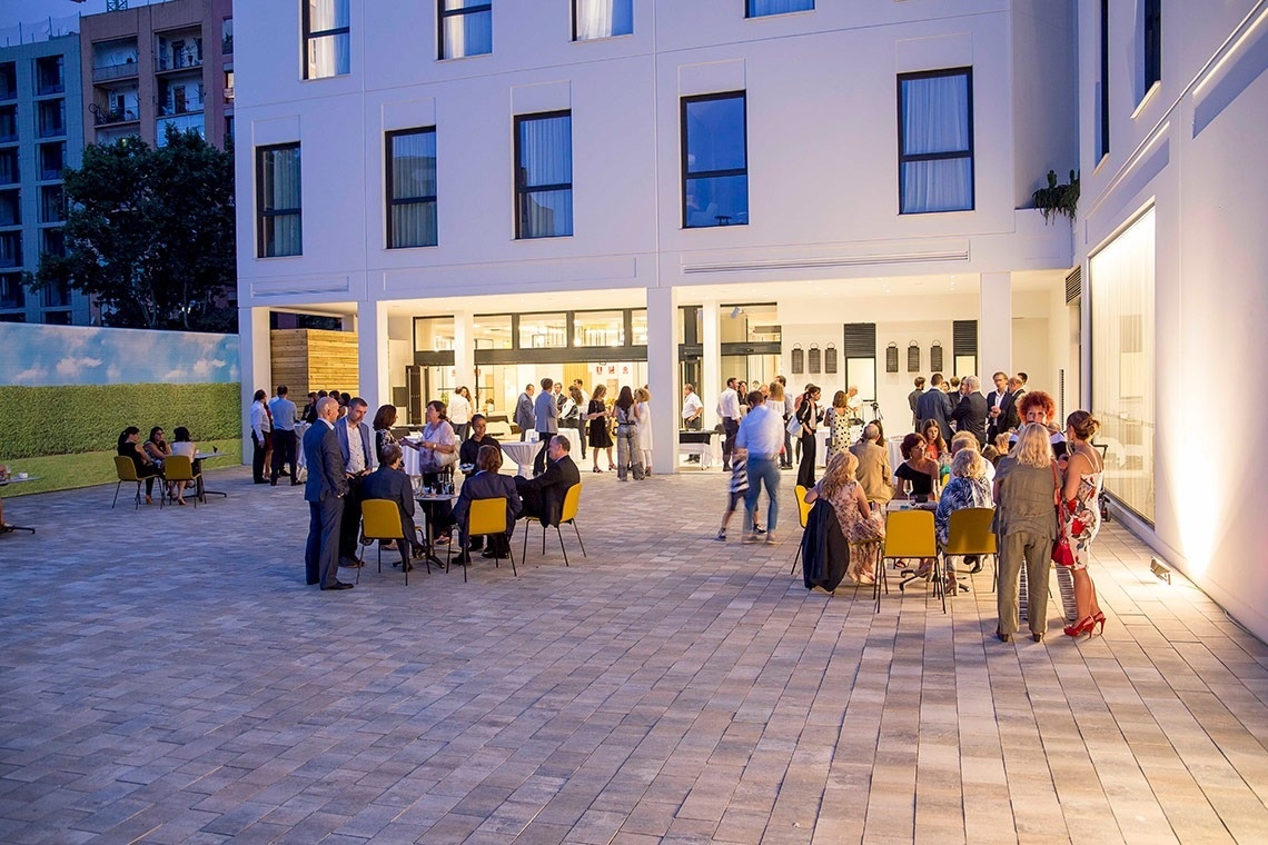 a group of people are gathered outside of a building