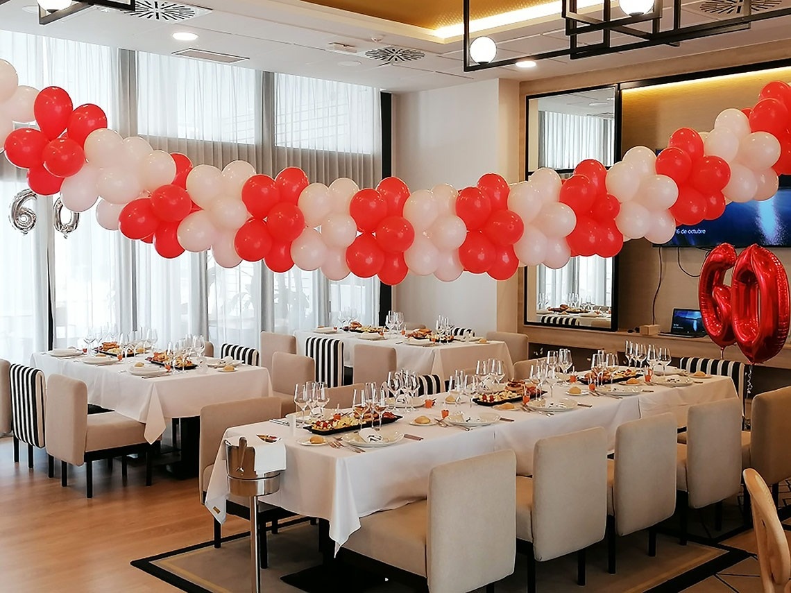 a red and white balloon with the number 60 on it