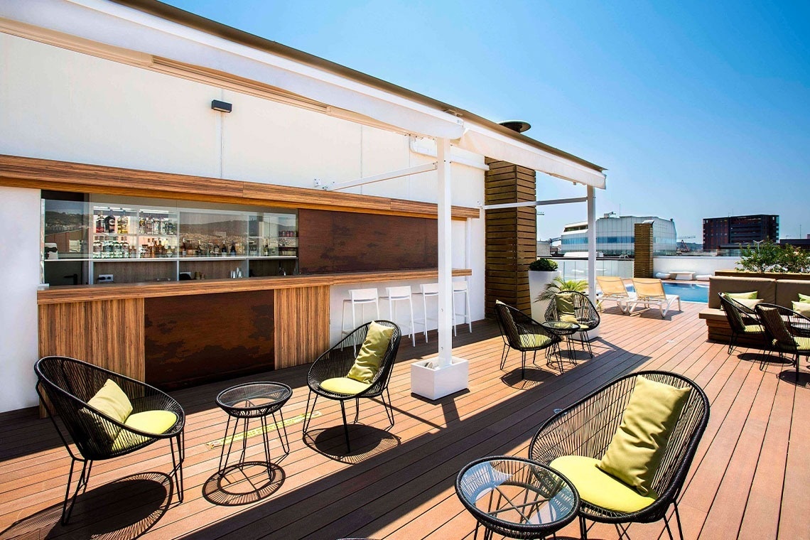 a restaurant with tables and chairs and a view of the ocean