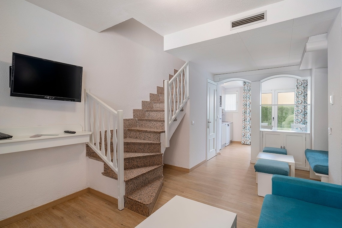 una habitación con escaleras y una televisión que dice asus