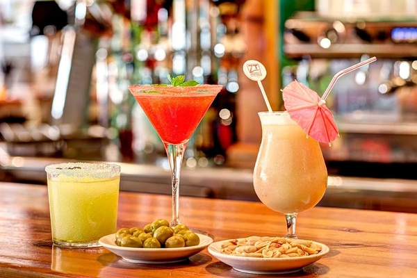 a large indoor swimming pool with chairs and a plant