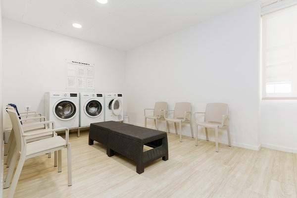 a large hotel with a large swimming pool in front of it