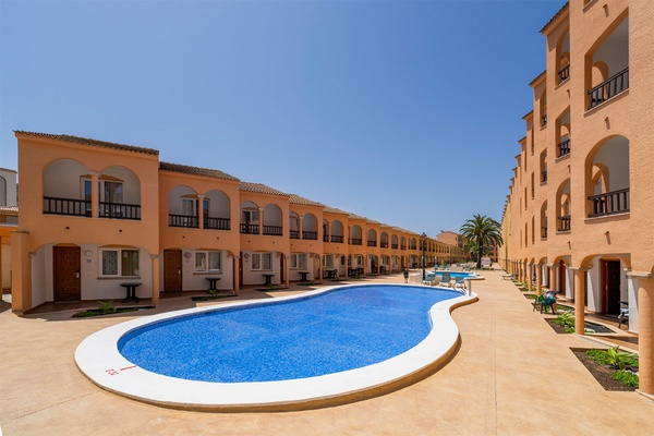 Jardines del Plaza pool and buildings. Sunny vacation.