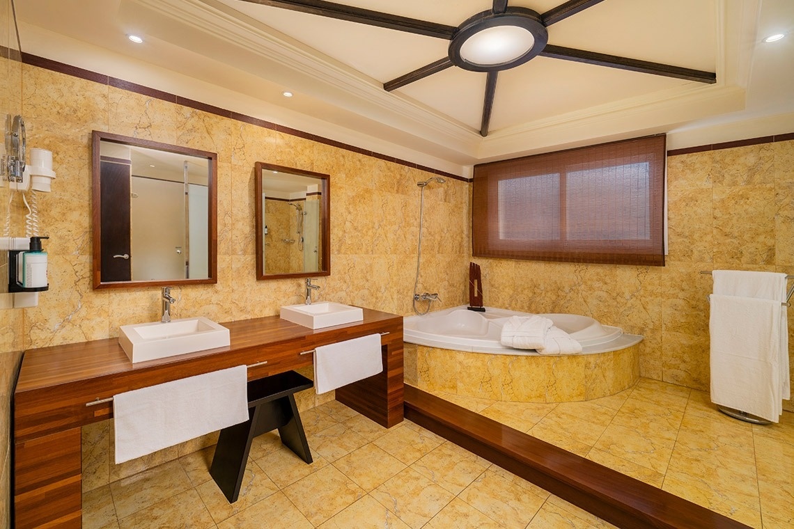 un baño con dos lavabos y una bañera