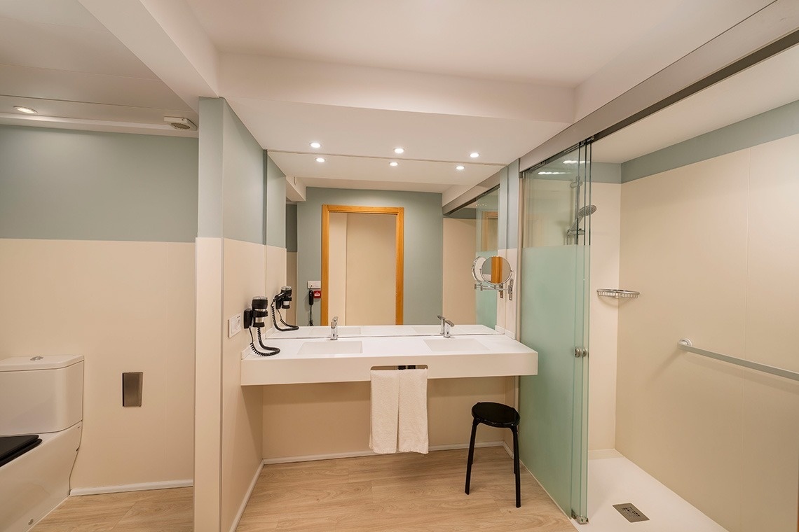 un baño con dos lavabos y una ducha