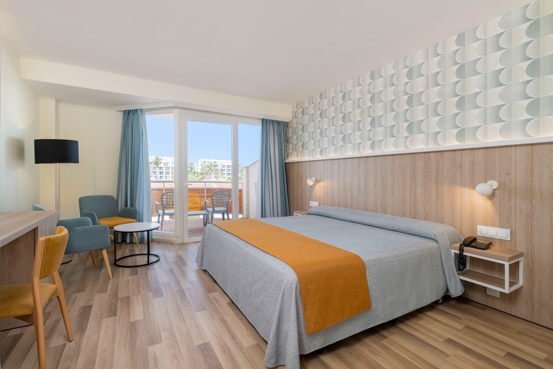 una habitación de hotel con dos camas y una mesa