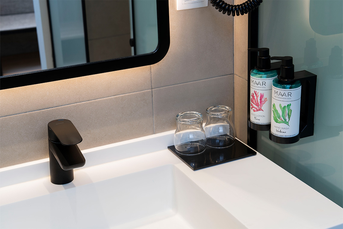 Modern bathroom sink with ZT: Villa Olimpica, soap dispensers, and glasses.
