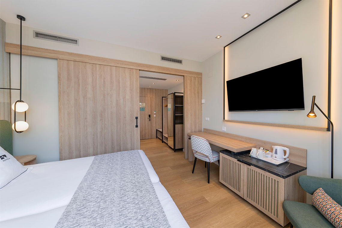 ZT: Villa Olimpica: Habitación moderna con cama, escritorio, TV y puerta corredera.